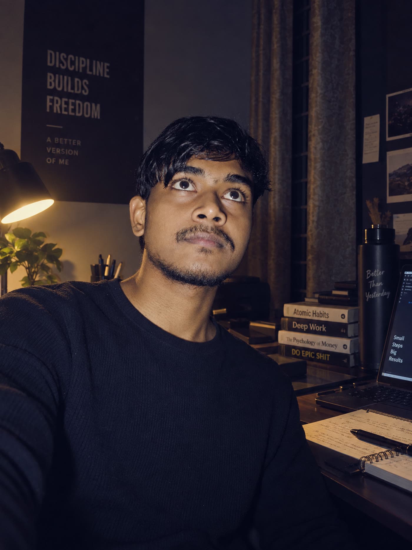 Abhi at the work desk, looking up from the screen